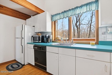 Set on a wooded corner parcel within the gated community of on Lords Valley Country Club, Inc in Pennsylvania - for sale on GolfHomes.com, golf home, golf lot