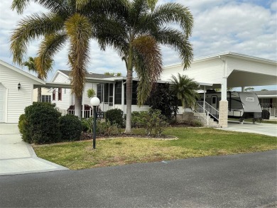 This house sits on a lot & 1/2 with an oversize two car garage on Lily Lake Golf and RV Resort in Florida - for sale on GolfHomes.com, golf home, golf lot