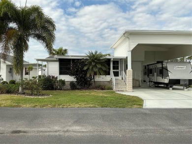 This house sits on a lot & 1/2 with an oversize two car garage on Lily Lake Golf and RV Resort in Florida - for sale on GolfHomes.com, golf home, golf lot