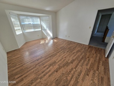 Imagine a charming two-story family home nestled in a serene on LakeRidge Golf Course in Nevada - for sale on GolfHomes.com, golf home, golf lot