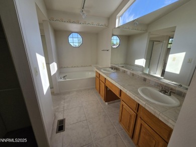 Imagine a charming two-story family home nestled in a serene on LakeRidge Golf Course in Nevada - for sale on GolfHomes.com, golf home, golf lot