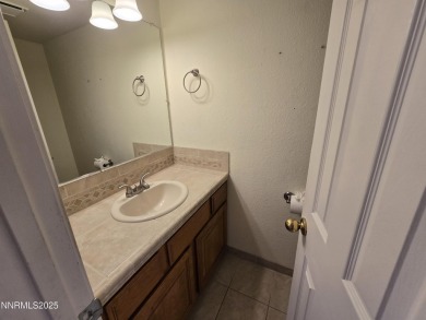Imagine a charming two-story family home nestled in a serene on LakeRidge Golf Course in Nevada - for sale on GolfHomes.com, golf home, golf lot