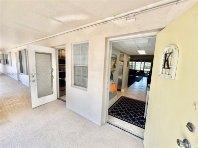 Welcome home to this warm and inviting, FULLY FURNISHED TURNKEY on Palm-Aire Country Club and Resort - Palms in Florida - for sale on GolfHomes.com, golf home, golf lot