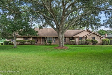Timeless and inviting, this all-brick, one-level home is nestled on The Deerwood Country Club in Florida - for sale on GolfHomes.com, golf home, golf lot