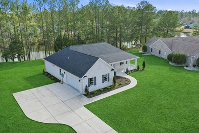 This brand-new, all-brick beauty delivers standout design on Long Bay Club in South Carolina - for sale on GolfHomes.com, golf home, golf lot