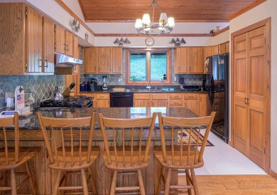 Tucked into the wooded hillside at the end of long ascending on Eagle Ridge Inn and Resort in Illinois - for sale on GolfHomes.com, golf home, golf lot
