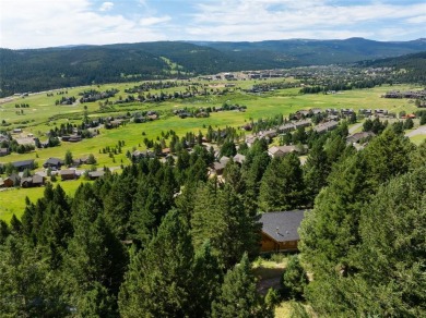 This charming log home, nestled in the trees and perched above on Big Sky of Montana Golf Course in Montana - for sale on GolfHomes.com, golf home, golf lot