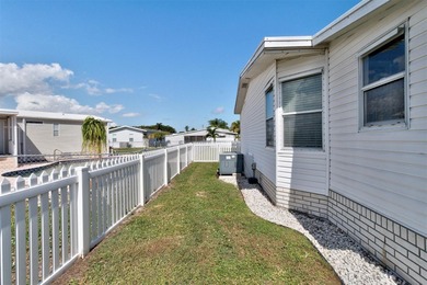Discover this beautifully updated split-bedroom home featuring on Barefoot Bay Golf Course in Florida - for sale on GolfHomes.com, golf home, golf lot