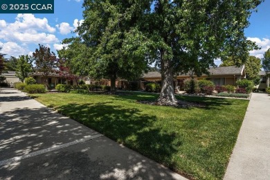 This bright and cheerful Sequoia Wrap end-unit is like a tree on Rossmoor Golf Course in California - for sale on GolfHomes.com, golf home, golf lot