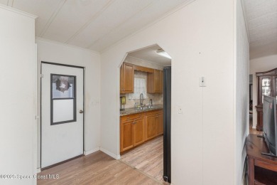 Own this home in the resort like community of Barefoot Bay on Barefoot Bay Golf Course in Florida - for sale on GolfHomes.com, golf home, golf lot
