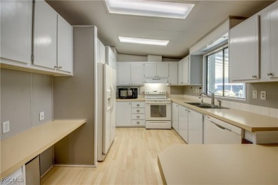 Remodeled with a new roof, new garage for golf cart, and a on Lake Fairways Country Club in Florida - for sale on GolfHomes.com, golf home, golf lot