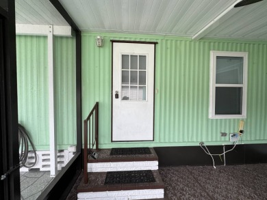 This immaculate, well-maintained 2 bedroom/2 bath manufactured on Lake Henry Golf Club in Florida - for sale on GolfHomes.com, golf home, golf lot