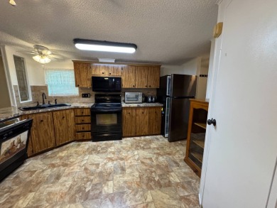 This immaculate, well-maintained 2 bedroom/2 bath manufactured on Lake Henry Golf Club in Florida - for sale on GolfHomes.com, golf home, golf lot