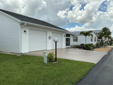 This home truly has it all! Attached RV port built to on Lily Lake Golf and RV Resort in Florida - for sale on GolfHomes.com, golf home, golf lot