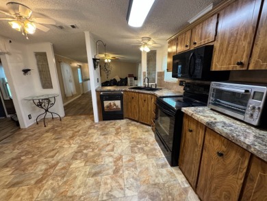 This immaculate, well-maintained 2 bedroom/2 bath manufactured on Lake Henry Golf Club in Florida - for sale on GolfHomes.com, golf home, golf lot