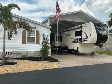This home truly has it all! Attached RV port built to on Lily Lake Golf and RV Resort in Florida - for sale on GolfHomes.com, golf home, golf lot