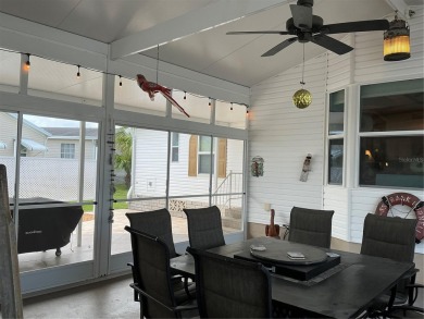 This home truly has it all! Attached RV port built to on Lily Lake Golf and RV Resort in Florida - for sale on GolfHomes.com, golf home, golf lot