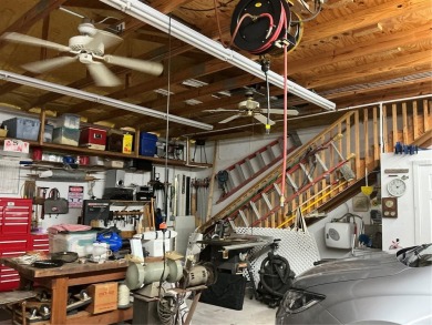 This home truly has it all! Attached RV port built to on Lily Lake Golf and RV Resort in Florida - for sale on GolfHomes.com, golf home, golf lot