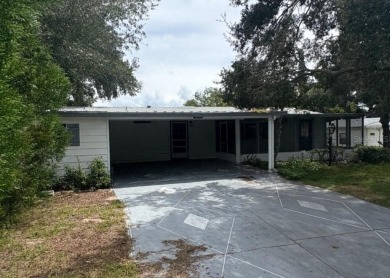 This home sits on a well manicured lot, with a wide driveway on Plantation Golf Club in Florida - for sale on GolfHomes.com, golf home, golf lot