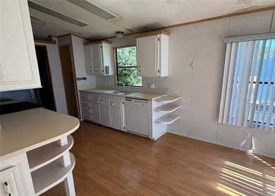 This home sits on a well manicured lot, with a wide driveway on Plantation Golf Club in Florida - for sale on GolfHomes.com, golf home, golf lot