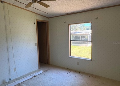 This home sits on a well manicured lot, with a wide driveway on Plantation Golf Club in Florida - for sale on GolfHomes.com, golf home, golf lot