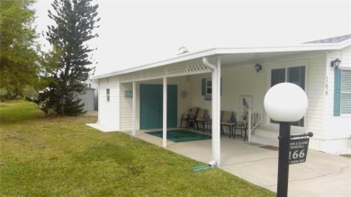 This adorable park model is conveniently located at the front of on Lily Lake Golf and RV Resort in Florida - for sale on GolfHomes.com, golf home, golf lot