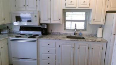This adorable park model is conveniently located at the front of on Lily Lake Golf and RV Resort in Florida - for sale on GolfHomes.com, golf home, golf lot