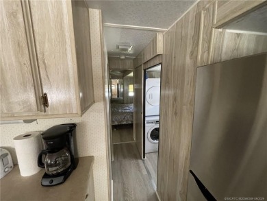 Step into coastal comfort with this 2 bedroom, 1 bathroom on Island Dunes Country Club in Florida - for sale on GolfHomes.com, golf home, golf lot