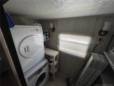 Step into coastal comfort with this 2 bedroom, 1 bathroom on Island Dunes Country Club in Florida - for sale on GolfHomes.com, golf home, golf lot