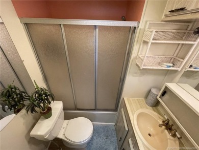 Step into coastal comfort with this 2 bedroom, 1 bathroom on Island Dunes Country Club in Florida - for sale on GolfHomes.com, golf home, golf lot