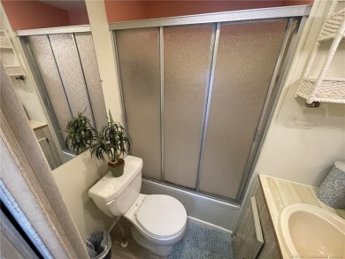 Step into coastal comfort with this 2 bedroom, 1 bathroom on Island Dunes Country Club in Florida - for sale on GolfHomes.com, golf home, golf lot