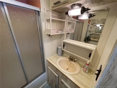 Step into coastal comfort with this 2 bedroom, 1 bathroom on Island Dunes Country Club in Florida - for sale on GolfHomes.com, golf home, golf lot