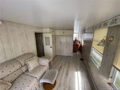 Step into coastal comfort with this 2 bedroom, 1 bathroom on Island Dunes Country Club in Florida - for sale on GolfHomes.com, golf home, golf lot