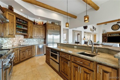 This stunning 5-bedroom, 4-bathroom custom home, built in 2011 on Laughlin Ranch Golf Club in Arizona - for sale on GolfHomes.com, golf home, golf lot