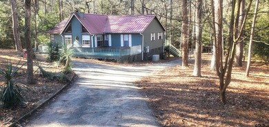 Beautiful chalet style home with Personality plus nestled on two on Holly Lake Ranch Golf Club in Texas - for sale on GolfHomes.com, golf home, golf lot