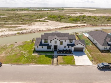 Discover luxury lakeside living in the prestigious gated on South Padre Island Golf Club in Texas - for sale on GolfHomes.com, golf home, golf lot