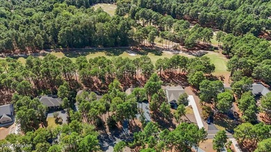 Nestled on the golf course in the gated community of Seven Lakes on Beacon Ridge Golf and Country Club in North Carolina - for sale on GolfHomes.com, golf home, golf lot