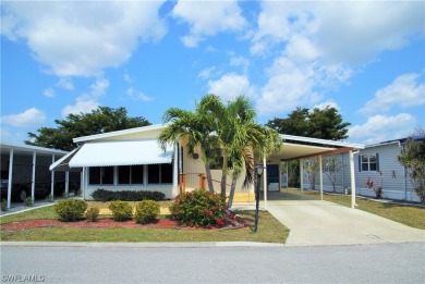 Move-in ready residence framed by swaying palms  adorned with on Six Lakes Country Club in Florida - for sale on GolfHomes.com, golf home, golf lot