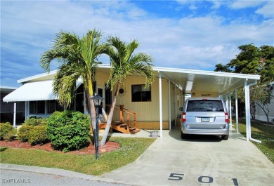 Move-in ready residence framed by swaying palms  adorned with on Six Lakes Country Club in Florida - for sale on GolfHomes.com, golf home, golf lot