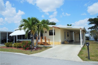 Move-in ready residence framed by swaying palms  adorned with on Six Lakes Country Club in Florida - for sale on GolfHomes.com, golf home, golf lot