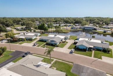 RARE OPPORTUNITY TO OWN A WATERFRONT CORNER VILLA NESTLED IN on Highland Lakes Executive Golf Course in Florida - for sale on GolfHomes.com, golf home, golf lot
