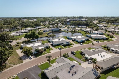 RARE OPPORTUNITY TO OWN A WATERFRONT CORNER VILLA NESTLED IN on Highland Lakes Executive Golf Course in Florida - for sale on GolfHomes.com, golf home, golf lot