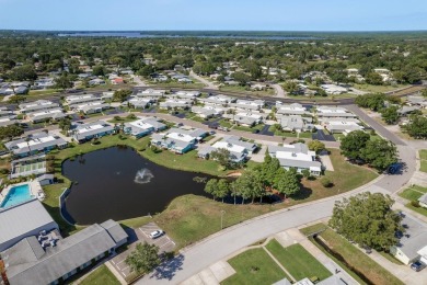 RARE OPPORTUNITY TO OWN A WATERFRONT CORNER VILLA NESTLED IN on Highland Lakes Executive Golf Course in Florida - for sale on GolfHomes.com, golf home, golf lot