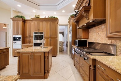 This exceptional 3-bedroom plus den, 3.5-bathroom estate home in on West Bay Beach and Golf Club in Florida - for sale on GolfHomes.com, golf home, golf lot