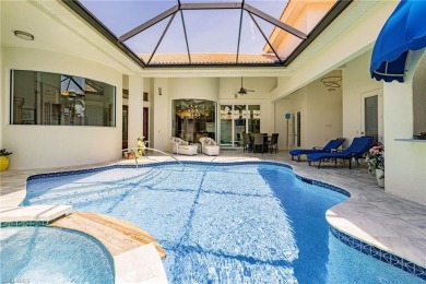 This exceptional 3-bedroom plus den, 3.5-bathroom estate home in on West Bay Beach and Golf Club in Florida - for sale on GolfHomes.com, golf home, golf lot
