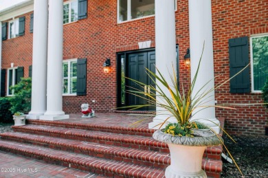 This exquisite brick home is tucked away on a cul-de-sac within on Pinewild Country Club of Pinehurst in North Carolina - for sale on GolfHomes.com, golf home, golf lot