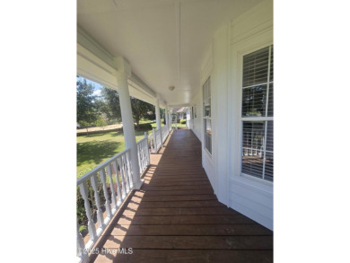 This charming farmhouse-style home with wraparound porches on Ocean Ridge Plantation in North Carolina - for sale on GolfHomes.com, golf home, golf lot