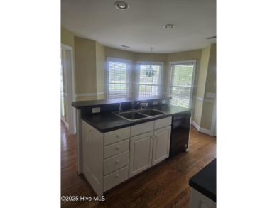 This charming farmhouse-style home with wraparound porches on Ocean Ridge Plantation in North Carolina - for sale on GolfHomes.com, golf home, golf lot