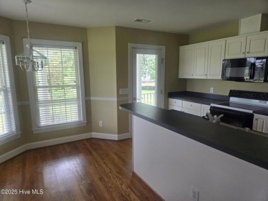 This charming farmhouse-style home with wraparound porches on Ocean Ridge Plantation in North Carolina - for sale on GolfHomes.com, golf home, golf lot