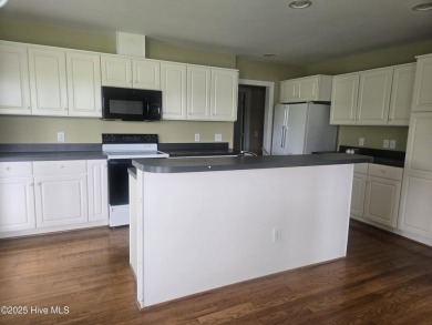 This charming farmhouse-style home with wraparound porches on Ocean Ridge Plantation in North Carolina - for sale on GolfHomes.com, golf home, golf lot